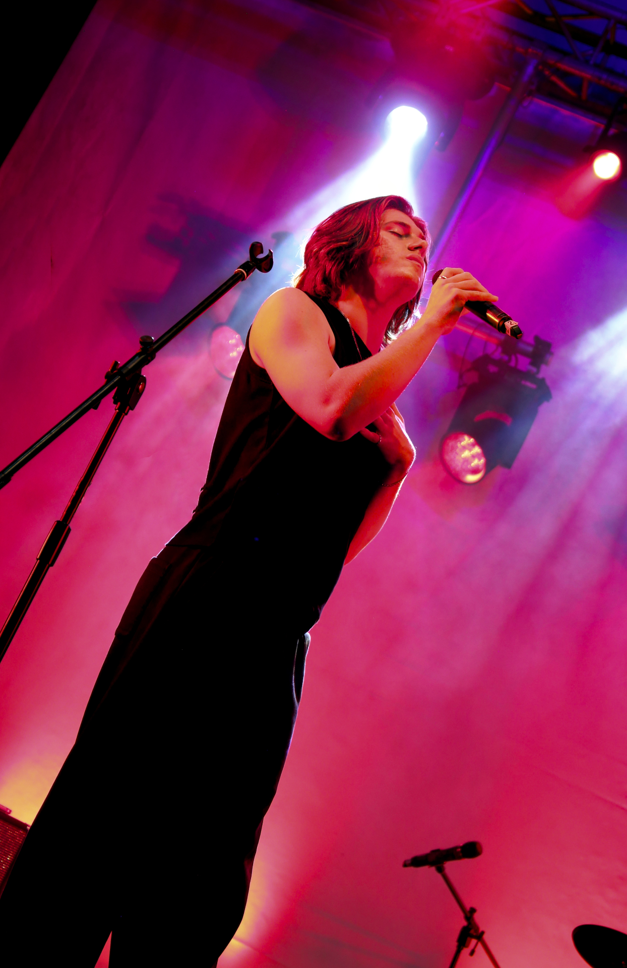 BRYCE performing under pink stage lights